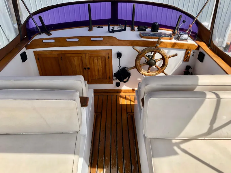 Slide: The Image of Cozy cabin bed in a 1978 CHB 34 boat with floral bedding and wooden interior. - 15