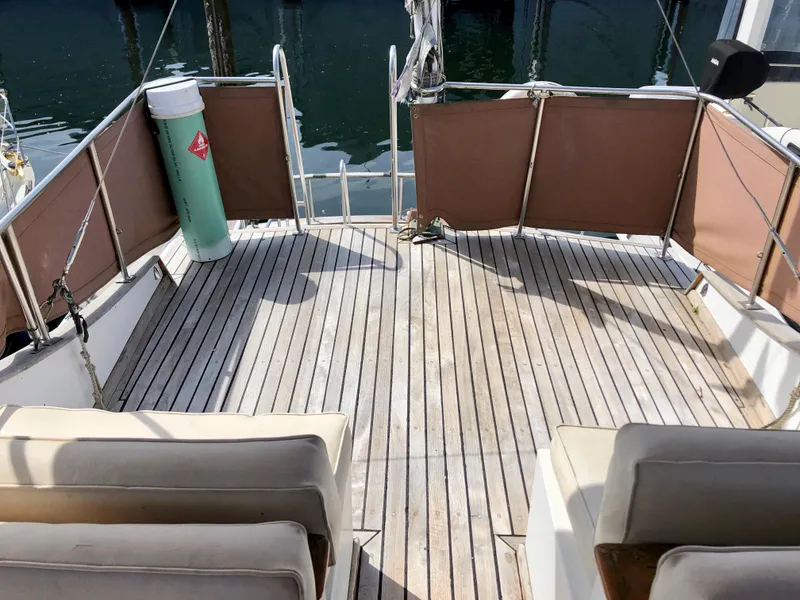 Slide: The Image of Cozy cabin bed in a 1978 CHB 34 boat with blue and red bedding. - 16