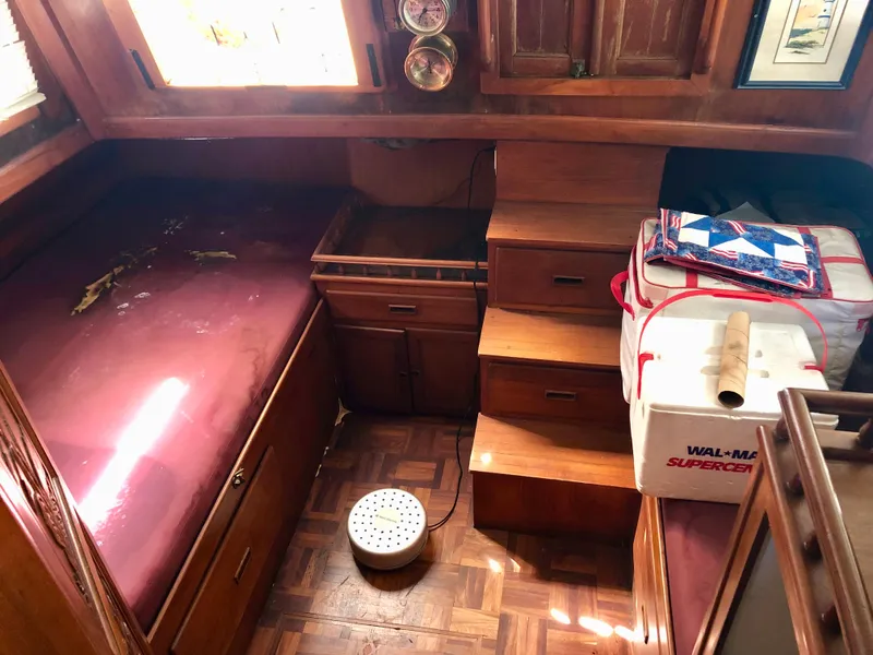 Slide: The Image of 1978 CHB 34 boat with wooden deck and blue canopy in a storage facility. - 2