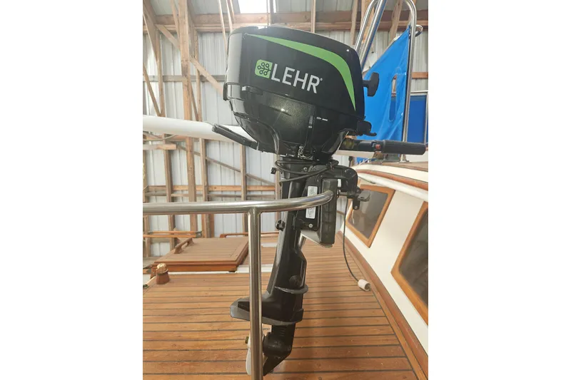 Slide: The Image of Outboard motor on a 1978 CHB 34 boat, docked in a wooden boathouse. - 22