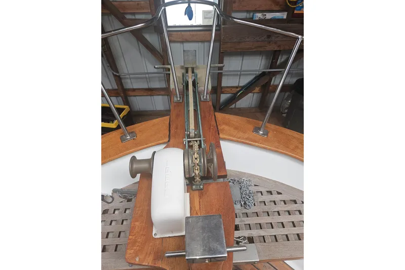 Slide: The Image of 1978 CHB 34 boat deck with anchor windlass and wooden railings in a boathouse. - 23