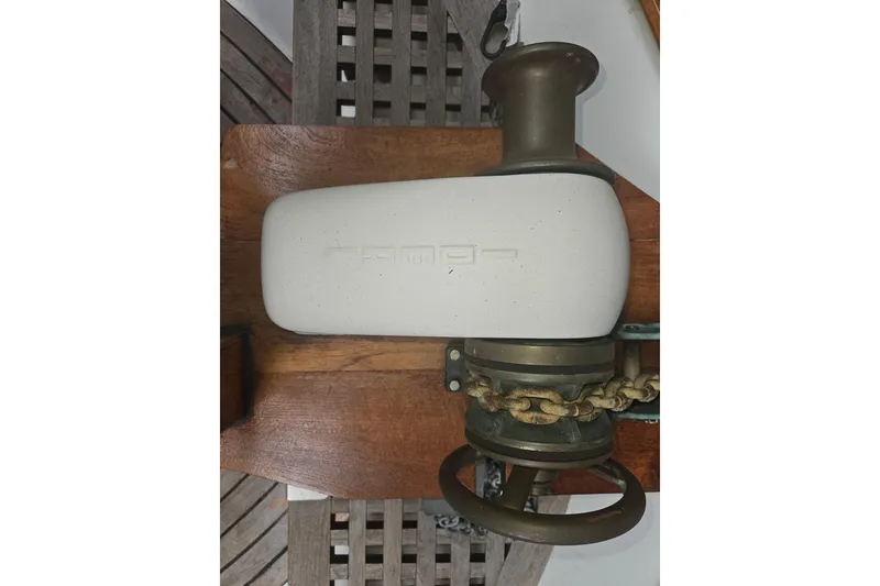 Slide: The Image of Vintage CHB 34 boat windlass from 1978 with chain and wooden base. - 24