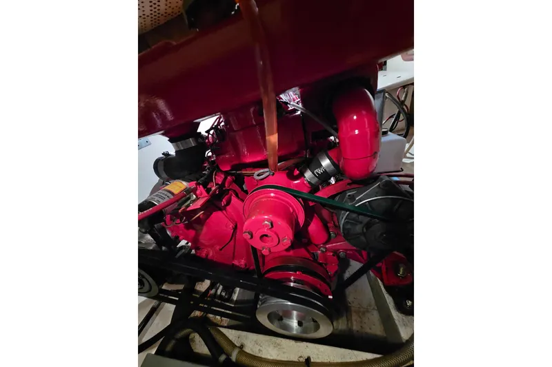 Slide: The Image of Red engine of a 1978 CHB 34 boat, showcasing mechanical components. - 27