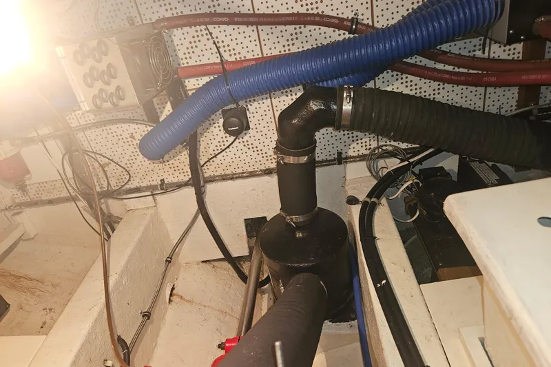 Slide: The Image of Engine room of a 1978 CHB 34 boat with visible hoses and wiring. - 30