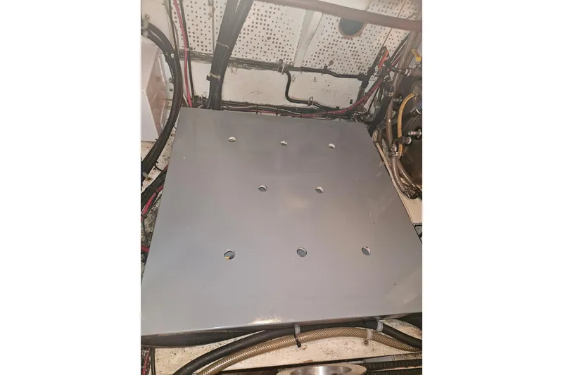 Slide: The Image of Engine compartment of a 1978 CHB 34 boat with visible wiring and metal panel. - 33