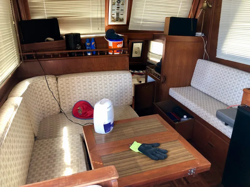 Slide: The Image of 1978 CHB 34 boat helm with wooden wheel, control panel, and storage cabinets. - 5