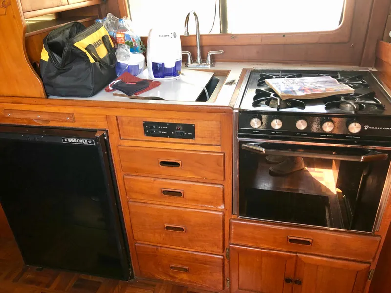 Slide: The Image of Blue cushioned seat on wooden interior of 1978 CHB 34 boat. - 7