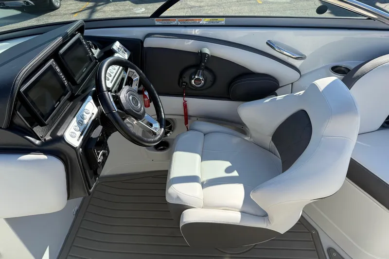 Slide: The Image of 2023 Crownline 290 SS boat cockpit with modern steering and controls. - 11
