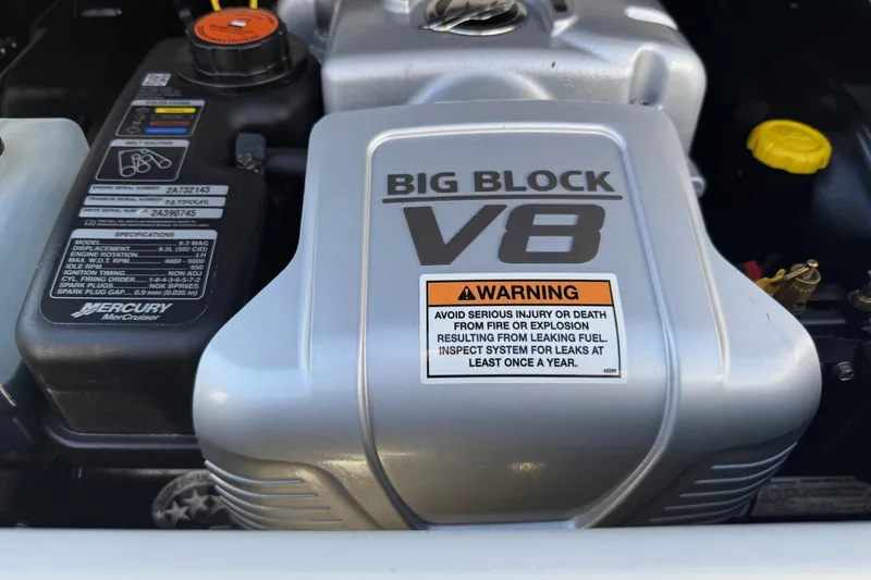 Slide: The Image of 2023 Crownline 290 SS engine, featuring a Big Block V8 with safety warning label. - 12