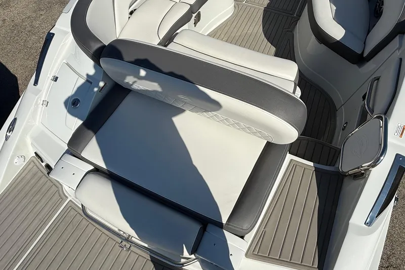 Slide: The Image of 2023 Crownline 290 SS boat interior with cushioned seating and sleek design. - 8
