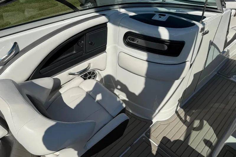 Slide: The Image of 2023 Crownline 290 SS boat interior with white seating and sleek dashboard design. - 9