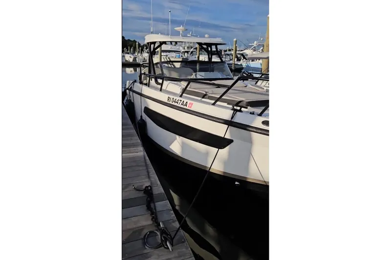 Slide: The Image of 2025 Navan S30 boat docked at marina, sleek design, sunny day. - 0