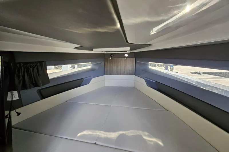 Slide: The Image of 2025 Navan S30 boat docked at marina, sleek design, sunny day. - 1