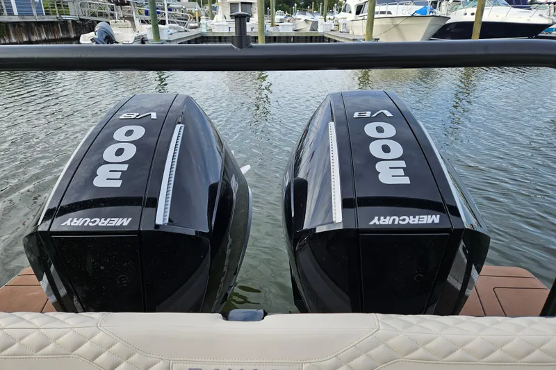 Slide: The Image of Navan S30 boat with open storage compartment and dual Mercury 300 engines, 2025 model. - 10