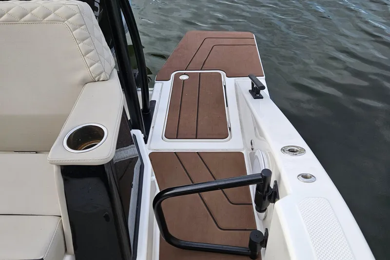 Slide: The Image of Navan S30 2025 boat interior with cushioned seating and dock view. - 12
