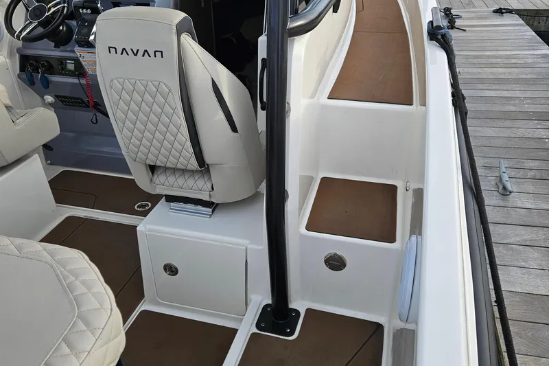 Slide: The Image of 2025 Navan S30 boat interior with luxurious seating and modern design at a dock. - 14