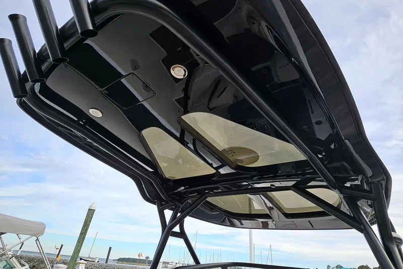 Slide: The Image of 2025 Navan S30 boat docked at marina, featuring spacious sunbathing area and scenic waterfront view. - 6