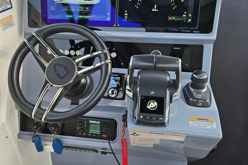 Slide: The Image of 2025 Navan S30 boat interior with control panel, cup holders, and speaker. - 8