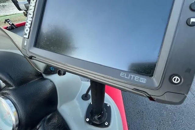 Slide: The Image of 2016 Tracker Pro Team 175 TXW boat dashboard with navigation system, parked near a river. - 12