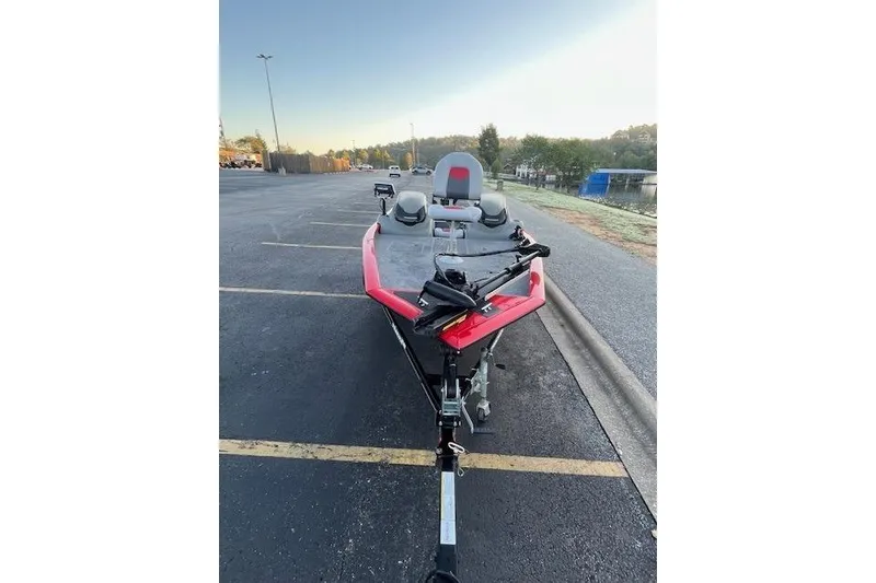 Slide: The Image of 2016 Tracker Pro Team 175 TXW boat with trolling motor by a lake. - 15