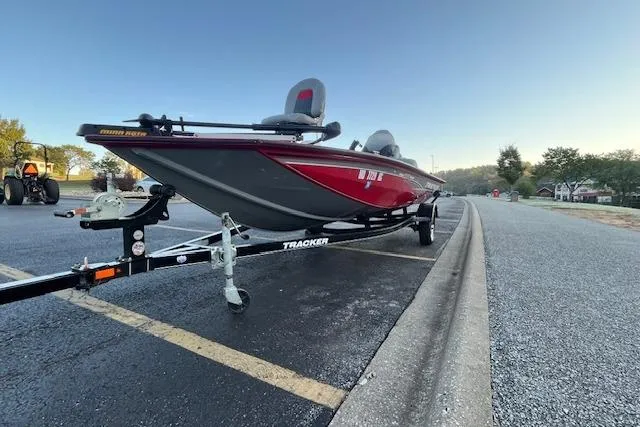 Slide: The Image of 2016 Tracker Pro Team 175 TXW boat, red and gray, parked on asphalt. - 16