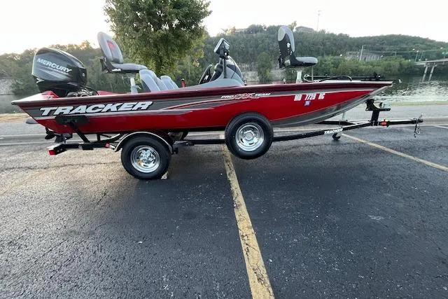 Slide: The Image of 2016 Tracker Pro Team 175 TXW boat interior with red trim and carpeted flooring. - 19