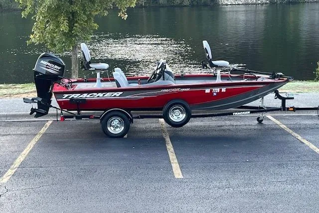 Slide: The Image of 2016 Tracker Pro Team 175 TXW boat on trailer by a lake. - 2
