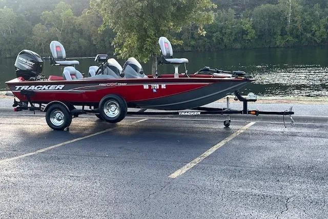 Slide: The Image of 2016 Tracker Pro Team 175 TXW boat on trailer by a scenic lake. - 4