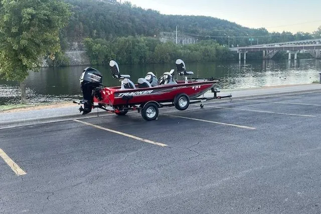 Slide: The Image of 2016 Tracker Pro Team 175 TXW boat on trailer by a lake. - 5