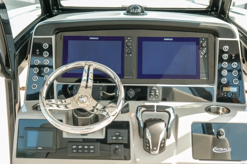 Slide: The Image of 2023 Robalo R270 Center Console dashboard with dual Simrad displays and modern controls. - 17