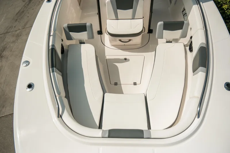 Slide: The Image of 2023 Robalo R270 Center Console boat interior with cushioned seating and storage. - 21