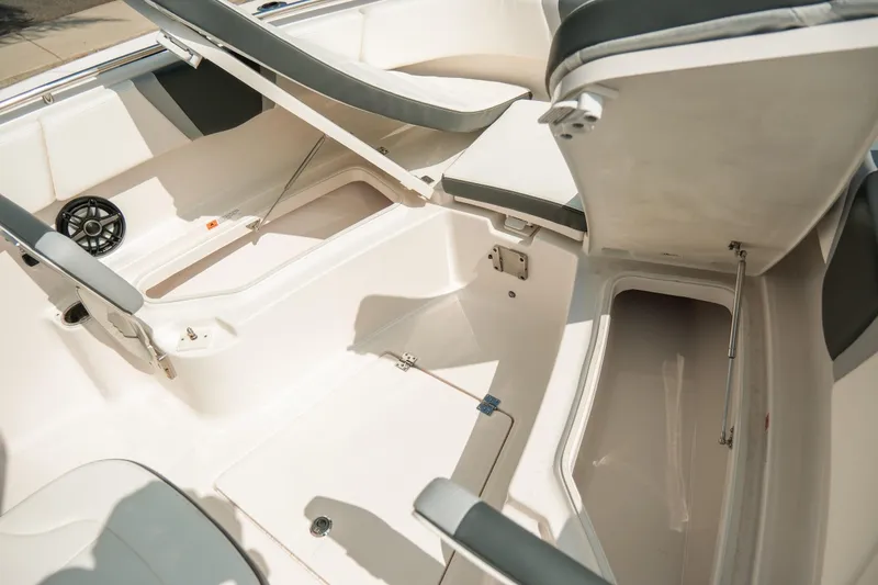 Slide: The Image of 2023 Robalo R270 Center Console boat interior with open storage compartments and seating. - 23