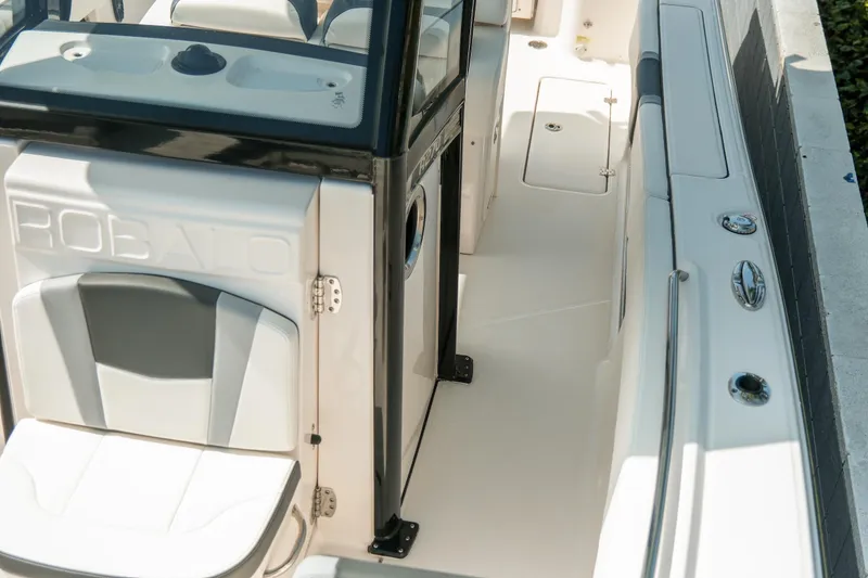 Slide: The Image of 2023 Robalo R270 Center Console boat interior with seating and storage compartments. - 25