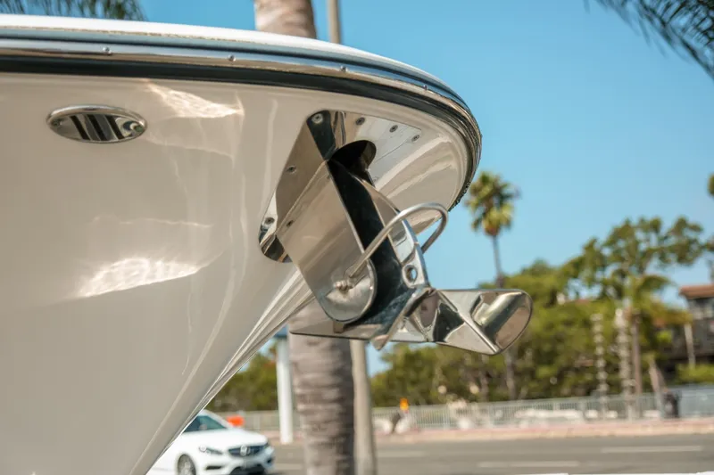 Slide: The Image of 2023 Robalo R270 Center Console boat anchor detail with palm trees in background. - 28