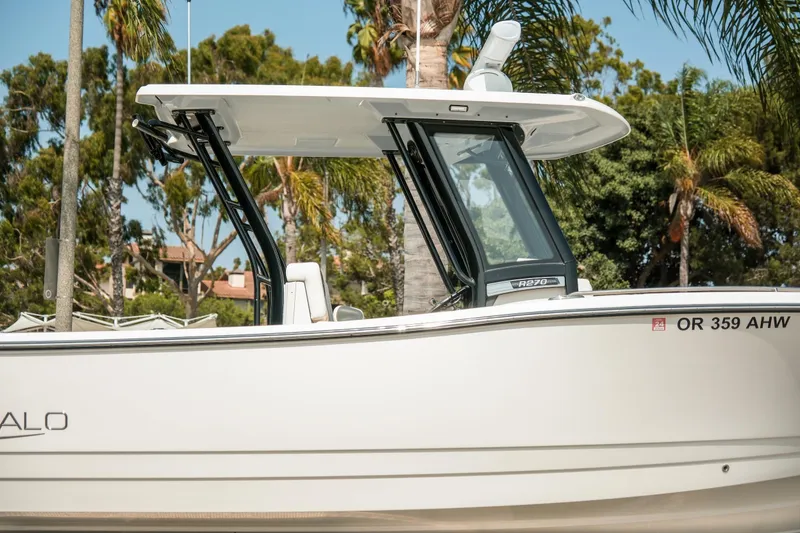 Slide: The Image of 2023 Robalo R270 Center Console boat with sleek design, set against a tropical backdrop. - 3