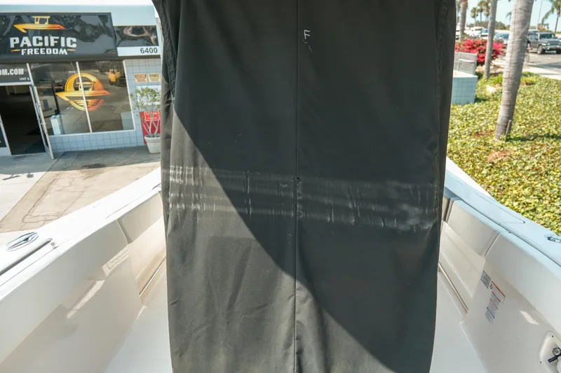 Slide: The Image of 2023 Robalo R270 Center Console boat with cover at Pacific Freedom dealership. - 39