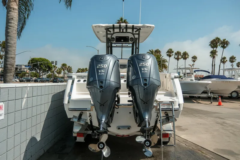 Slide: The Image of 2023 Robalo R270 Center Console with dual Yamaha 250 V6 engines, docked outdoors. - 5