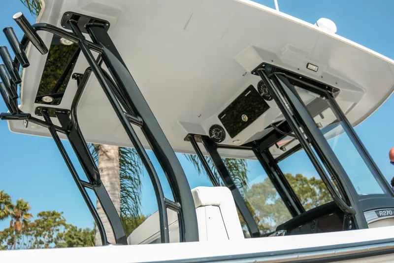 Slide: The Image of 2023 Robalo R270 Center Console boat with sleek black frame and modern design. - 6