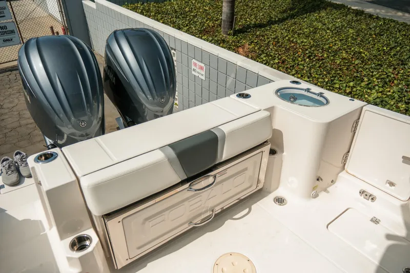 Slide: The Image of 2023 Robalo R270 Center Console boat with dual Yamaha engines and spacious seating area. - 8
