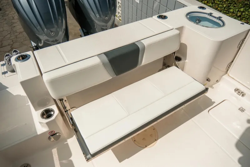 Slide: The Image of 2023 Robalo R270 Center Console boat with foldable seating and dual engines. - 9