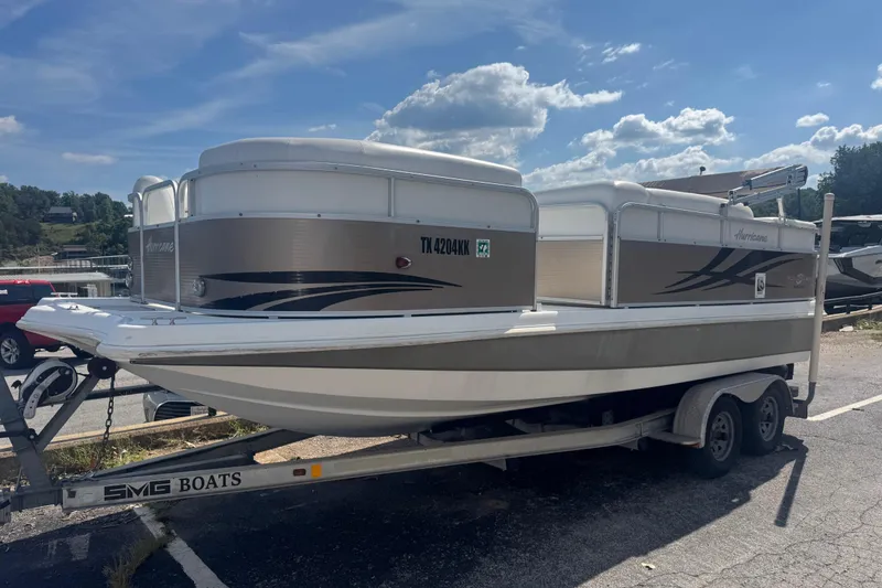 Slide: The Image of 2013 Hurricane Fundeck 216 boat on trailer under a clear blue sky. - 0