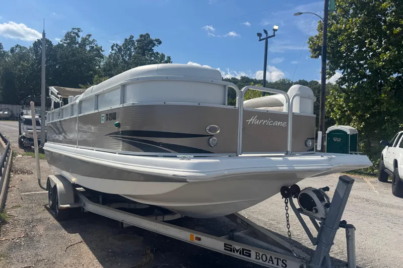 Slide: The Image of 2013 Hurricane Fundeck 216 boat on trailer in sunny outdoor setting. - 2