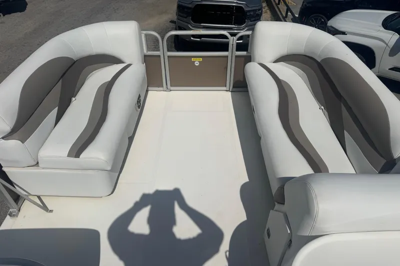 Slide: The Image of 2013 Hurricane Fundeck 216 interior with white and gray seating, parked outdoors. - 4