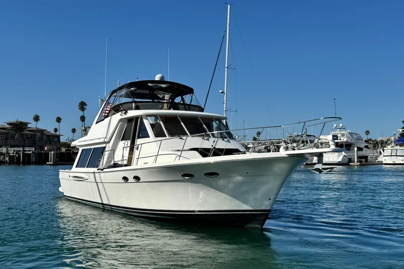 The Image of 2006 Meridian 490 Pilothouse yacht docked in a sunny marina. - 0