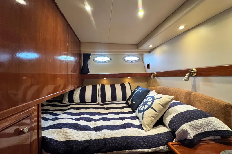 Slide: The Image of Luxurious cabin interior of 2006 Meridian 490 Pilothouse yacht with nautical-themed bedding. - 12