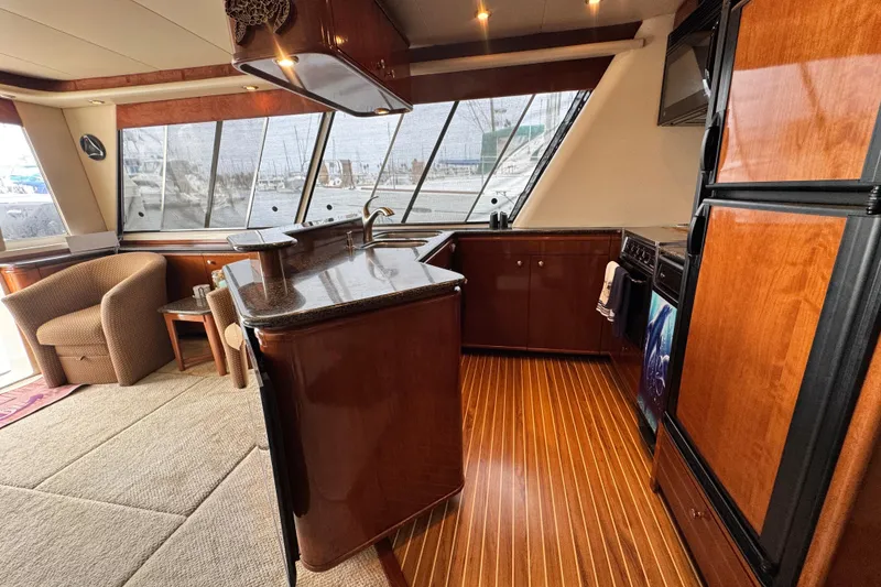 Slide: The Image of Luxurious 2006 Meridian 490 Pilothouse interior with elegant wood finishes and modern kitchen amenities. - 14