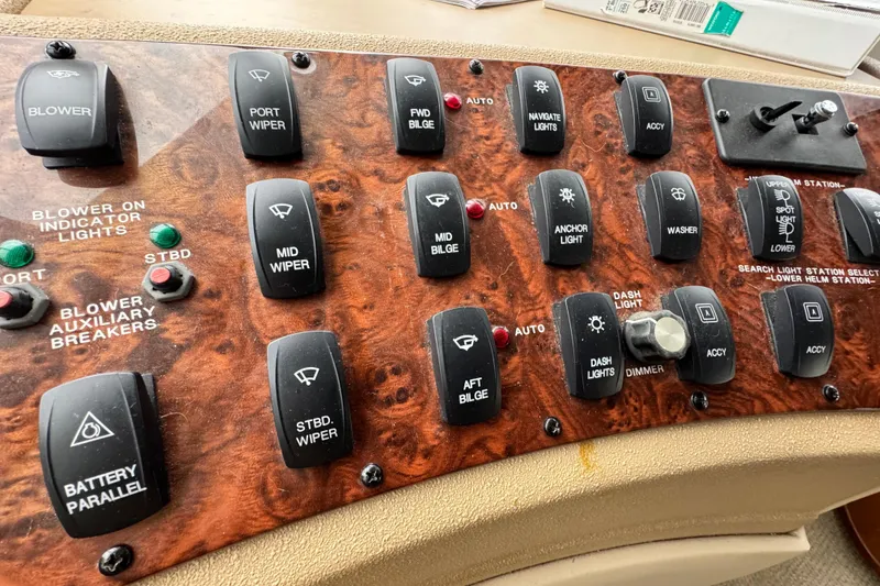 Slide: The Image of Control panel of a 2006 Meridian 490 Pilothouse boat with various switches. - 19