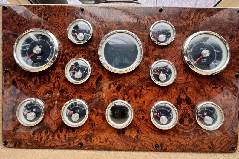 Slide: The Image of Dashboard of a 2006 Meridian 490 Pilothouse with multiple gauges and wood finish. - 20