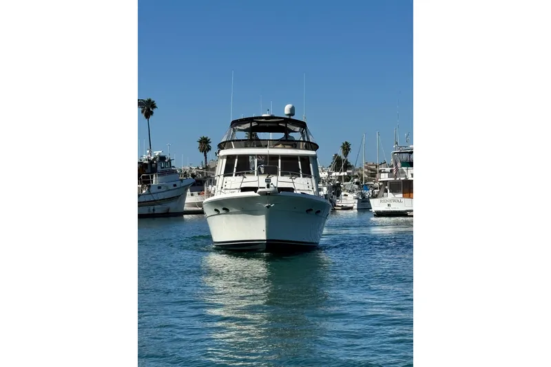 Slide: The Image of 2006 Meridian 490 Pilothouse yacht cruising in a sunny marina. - 24