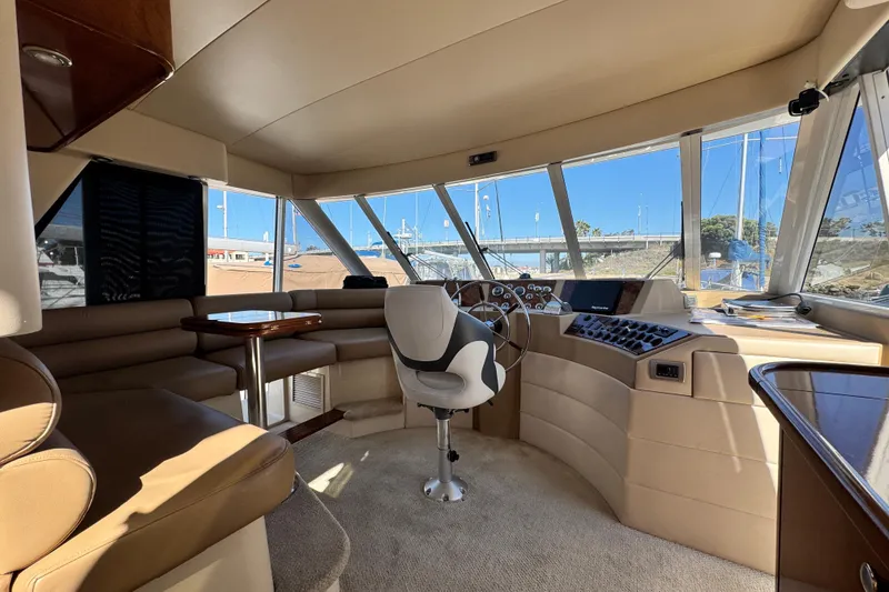 Slide: The Image of Interior of 2006 Meridian 490 Pilothouse with helm, seating, and panoramic windows. - 25